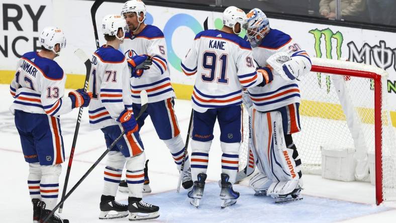 Feb 9, 2024; Anaheim, California, USA; Edmonton Oilers left wing Evander Kane (91) and goaltender Calvin Pickard (30) celebrate after the Edmonton Oilers defeat the Anaheim Ducks at Honda Center. Mandatory Credit: Jessica Alcheh-USA TODAY Sports