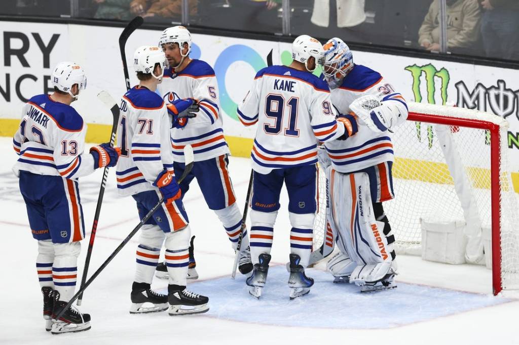 Feb 9, 2024; Anaheim, California, USA; Edmonton Oilers left wing Evander Kane (91) and goaltender Calvin Pickard (30) celebrate after the Edmonton Oilers defeat the Anaheim Ducks at Honda Center. Mandatory Credit: Jessica Alcheh-USA TODAY Sports