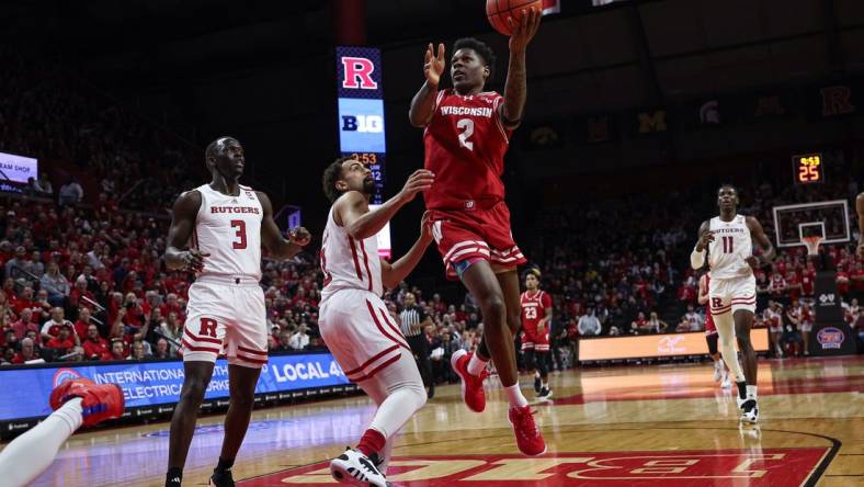 Feb 10, 2024; Piscataway, New Jersey, USA; Wisconsin Badgers guard AJ Storr (2) drives for a shot against Rutgers Scarlet Knights guard Noah Fernandes (2) and forward Mawot Mag (3) during the first half at Jersey Mike's Arena. Mandatory Credit: Vincent Carchietta-USA TODAY Sports