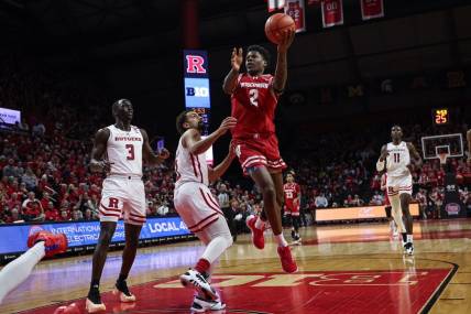Feb 10, 2024; Piscataway, New Jersey, USA; Wisconsin Badgers guard AJ Storr (2) drives for a shot against Rutgers Scarlet Knights guard Noah Fernandes (2) and forward Mawot Mag (3) during the first half at Jersey Mike's Arena. Mandatory Credit: Vincent Carchietta-USA TODAY Sports
