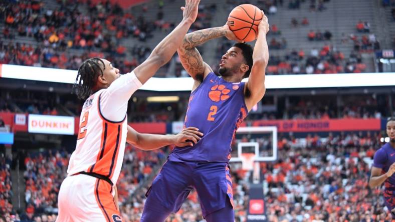 Feb 10, 2024; Syracuse, New York, USA; Clemson Tigers guard Dillon Hunter (2) shoots over Syracuse Orange guard JJ Starling in the first half at the JMA Wireless Dome. Mandatory Credit: Mark Konezny-USA TODAY Sports