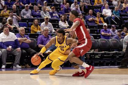 Feb 10, 2024; Baton Rouge, Louisiana, USA;  LSU Tigers guard Jordan Wright (6) dribbles the ball against Alabama Crimson Tide forward Mouhamed Dioubate (10) during the first half at Pete Maravich Assembly Center. Mandatory Credit: Stephen Lew-USA TODAY Sports