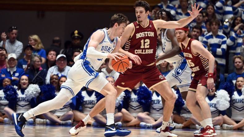 Feb 10, 2024; Durham, North Carolina, USA; Duke Blue Devils center Kyle Filipowski (30) drives to the basket against Boston College Eagles center Quinten Post (12) during the first half  at Cameron Indoor Stadium. Mandatory Credit: Rob Kinnan-USA TODAY Sports