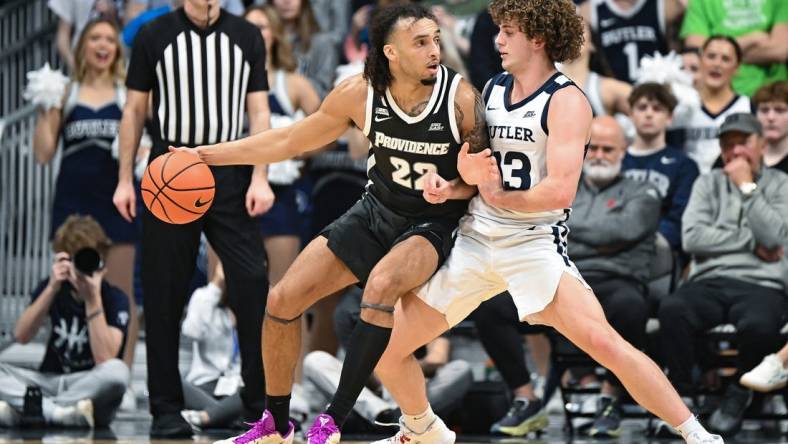 Feb 10, 2024; Indianapolis, Indiana, USA;  Providence Friars guard Devin Carter (22) dribbles against Butler Bulldogs guard Finley Bizjack (13) during the first half at Hinkle Fieldhouse. Mandatory Credit: Robert Goddin-USA TODAY Sports