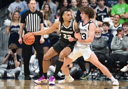 Feb 10, 2024; Indianapolis, Indiana, USA;  Providence Friars guard Devin Carter (22) dribbles against Butler Bulldogs guard Finley Bizjack (13) during the first half at Hinkle Fieldhouse. Mandatory Credit: Robert Goddin-USA TODAY Sports