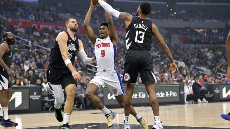 Feb 10, 2024; Los Angeles, California, USA;  Detroit Pistons forward Ausar Thompson (9) is defended by Los Angeles Clippers center Ivica Zubac (40) and forward Paul George (13) as he drives to the basket in the first half at Crypto.com Arena. Mandatory Credit: Jayne Kamin-Oncea-USA TODAY Sports