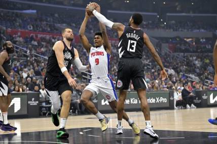 Feb 10, 2024; Los Angeles, California, USA;  Detroit Pistons forward Ausar Thompson (9) is defended by Los Angeles Clippers center Ivica Zubac (40) and forward Paul George (13) as he drives to the basket in the first half at Crypto.com Arena. Mandatory Credit: Jayne Kamin-Oncea-USA TODAY Sports