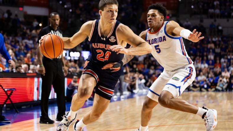 Feb 10, 2024; Gainesville, Florida, USA; Auburn Tigers guard Lior Berman (24) drives to the basket against Florida Gators guard Will Richard (5) during the first half at Exactech Arena at the Stephen C. O'Connell Center. Mandatory Credit: Matt Pendleton-USA TODAY Sports