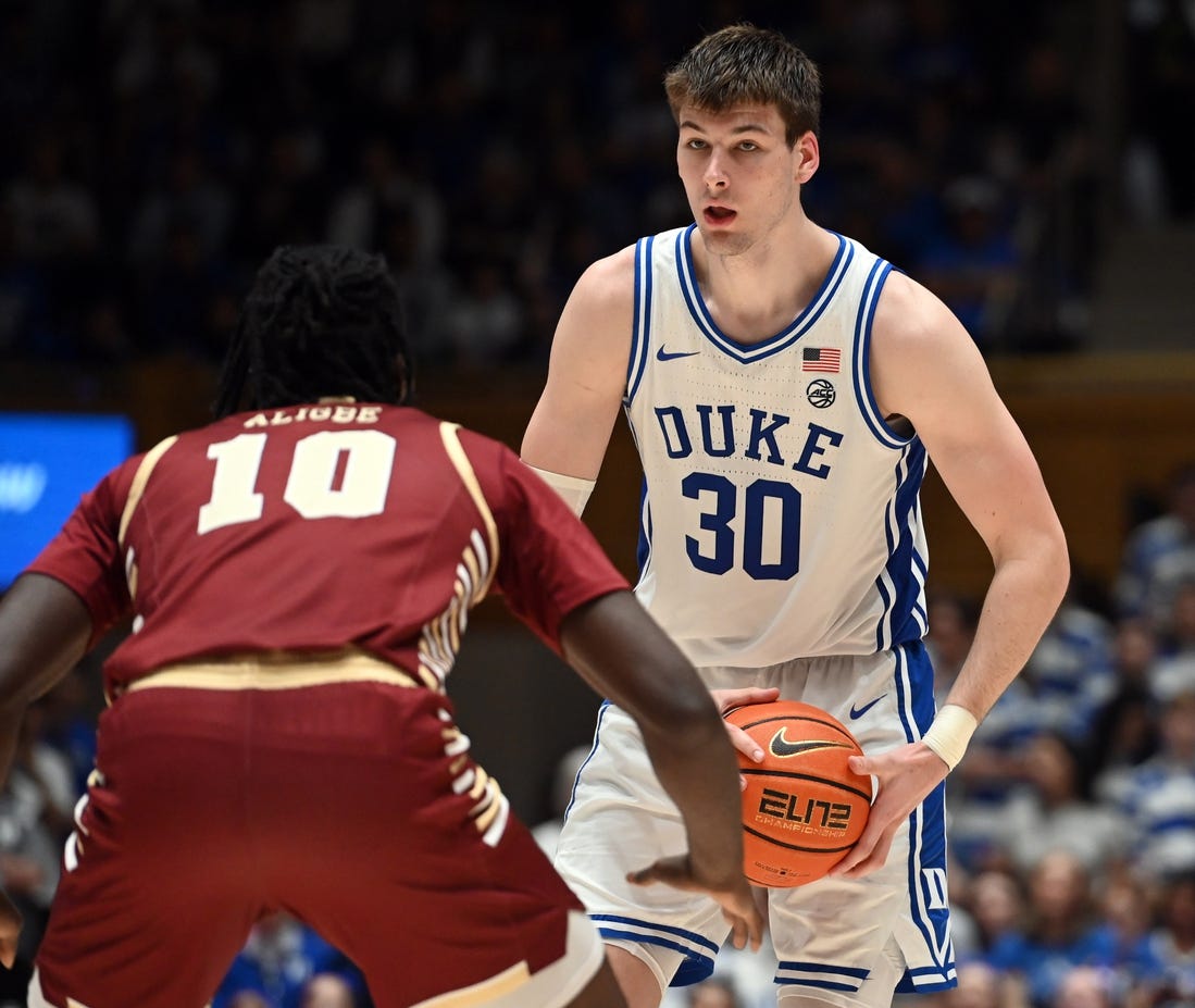 Feb 10, 2024; Durham, North Carolina, USA; Duke Blue Devils center Kyle Filipowski (30) controls the ball in front of Boston College Eagles forward Prince Aligbe (10) during the second half at Cameron Indoor Stadium. Mandatory Credit: Rob Kinnan-USA TODAY Sports