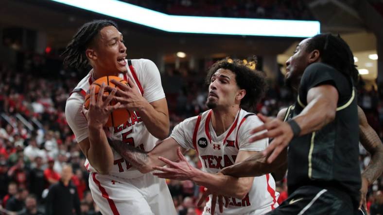 Feb 10, 2024; Lubbock, Texas, USA;  Texas Tech Red Raiders guard Darrion Williams (5) grabs a rebound in front of guard Pop Isaacs (2) and Central Florida Knights guard Shaemarri Allen (2) in the first half United Supermarkets Arena. Mandatory Credit: Michael C. Johnson-USA TODAY Sports