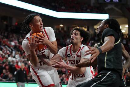 Feb 10, 2024; Lubbock, Texas, USA;  Texas Tech Red Raiders guard Darrion Williams (5) grabs a rebound in front of guard Pop Isaacs (2) and Central Florida Knights guard Shaemarri Allen (2) in the first half United Supermarkets Arena. Mandatory Credit: Michael C. Johnson-USA TODAY Sports
