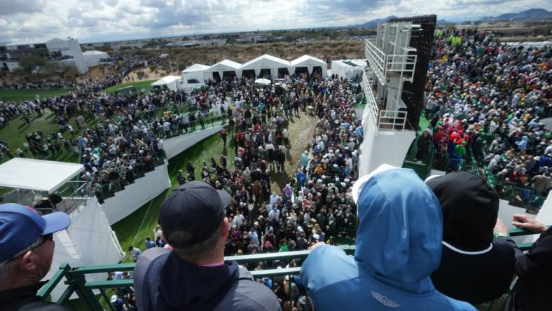 Feb 10, 2024; Scottsdale, AZ, USA; Fans look out from the stands on the 16th hole during the 2024 Phoenix Open at TPC Scottsdale.