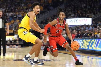 Feb 10, 2024; Milwaukee, Wisconsin, USA;  St. John's Red Storm guard Daniss Jenkins (5) drives for the basket against Marquette Golden Eagles forward Oso Ighodaro (13) during the first half at Fiserv Forum. Mandatory Credit: Jeff Hanisch-USA TODAY Sports