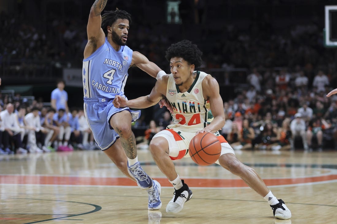 Feb 10, 2024; Coral Gables, Florida, USA; Miami Hurricanes guard Nijel Pack (24) drives to the basket past North Carolina Tar Heels guard RJ Davis (4) during the second half at Watsco Center. Mandatory Credit: Sam Navarro-USA TODAY Sports