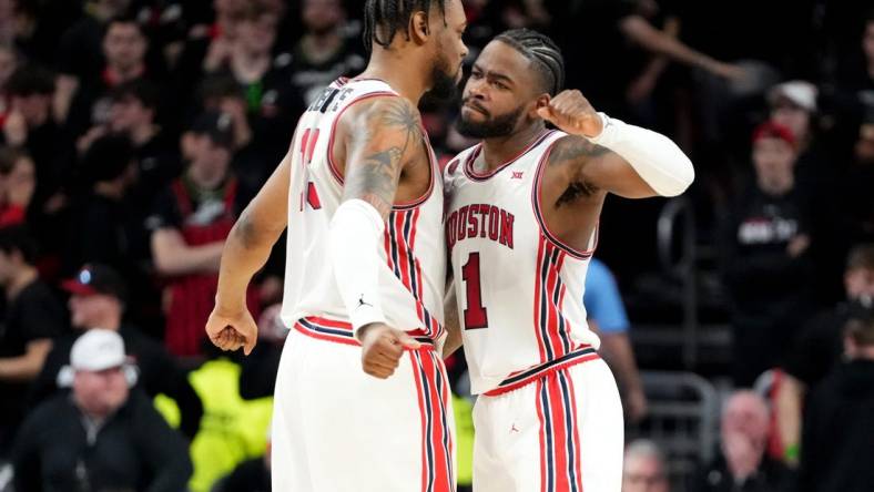 Houston Cougars forward J'Wan Roberts (13) and Houston Cougars guard Jamal Shead (1) celebrate the win at the conclusion of the second half of an NCAA college basketball game against the Cincinnati Bearcats, Saturday, Feb. 10, 2024, at Fifth Third Arena in Cincinnati.