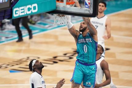 Feb 10, 2024; Charlotte, North Carolina, USA; Charlotte Hornets forward Miles Bridges (0) goes up for a dunk against the Memphis Grizzlies during the second quarter at Spectrum Center. Mandatory Credit: Jim Dedmon-USA TODAY Sports