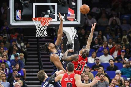 Feb 10, 2024; Orlando, Florida, USA; Chicago Bulls forward DeMar DeRozan (11) goes to the basket against Orlando Magic center Wendell Carter Jr. (34) during the second quarter at KIA Center. Mandatory Credit: Mike Watters-USA TODAY Sports