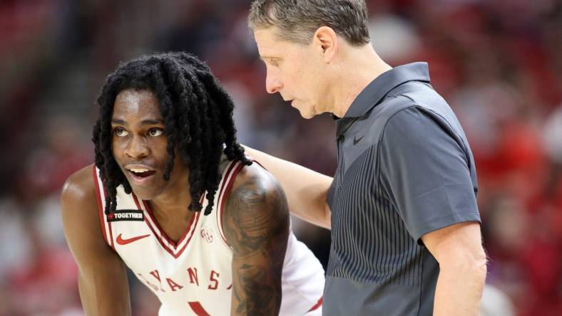 Feb 10, 2024; Fayetteville, Arkansas, USA; Arkansas Razorbacks guard Keyon Menifield Jr (1) talks to head coach Eric Musselman during the second half against the Georgia Bulldogs at Bud Walton Arena. Arkansas won 78-75. Mandatory Credit: Nelson Chenault-USA TODAY Sports