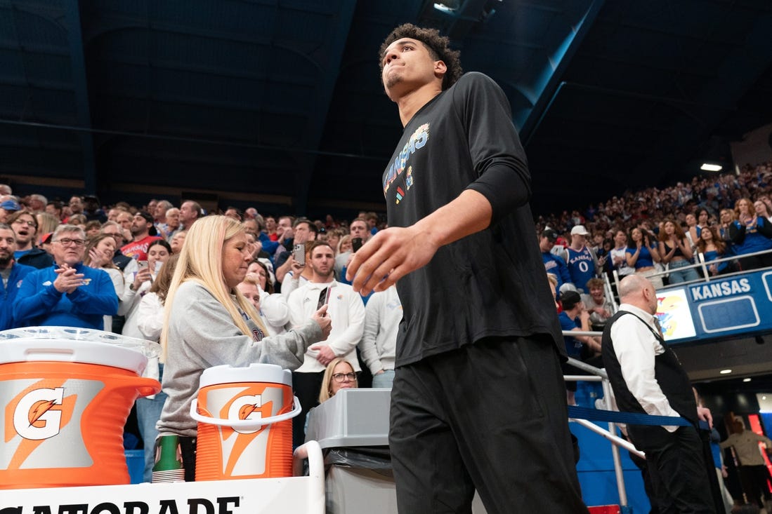 Kansas graduate senior guard Kevin McCullar Jr. (15) walks on to the court before the Jayhawks take on Baylor inside Allen Fieldhouse Saturday, February 10, 2024. McCullar did not play due to injury.