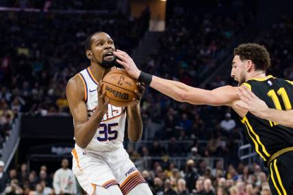 Feb 10, 2024; San Francisco, California, USA; Phoenix Suns forward Kevin Durant (35) is defended by Golden State Warriors guard Klay Thompson (11)  during the first half at Chase Center. Mandatory Credit: John Hefti-USA TODAY Sports