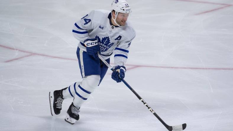 Feb 10, 2024; Ottawa, Ontario, CAN; Toronto Maple Leafs defenseman Morgan Rielly (44) skates with the puck in the third period against the Ottawa Senators at the Canadian Tire Centre. Mandatory Credit: Marc DesRosiers-USA TODAY Sports