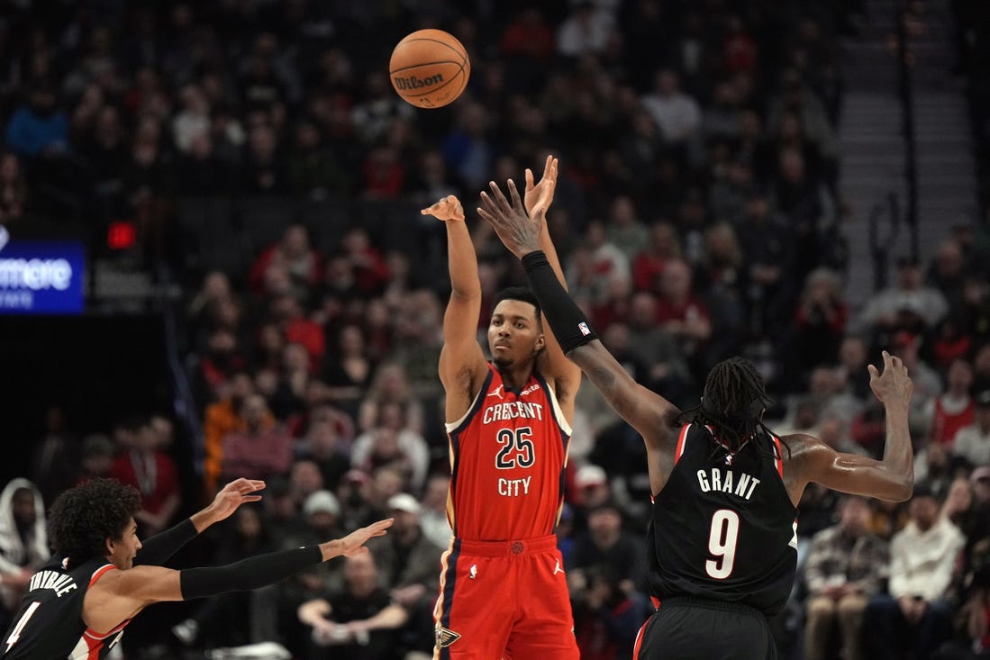 Feb 10, 2024; Portland, Oregon, USA; New Orleans Pelicans shooting guard Trey Murphy III (25) shoots the ball over Portland Trail Blazers small forward Jerami Grant (9) during the first half at Moda Center. Mandatory Credit: Soobum Im-USA TODAY Sports