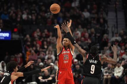 Feb 10, 2024; Portland, Oregon, USA; New Orleans Pelicans shooting guard Trey Murphy III (25) shoots the ball over Portland Trail Blazers small forward Jerami Grant (9) during the first half at Moda Center. Mandatory Credit: Soobum Im-USA TODAY Sports