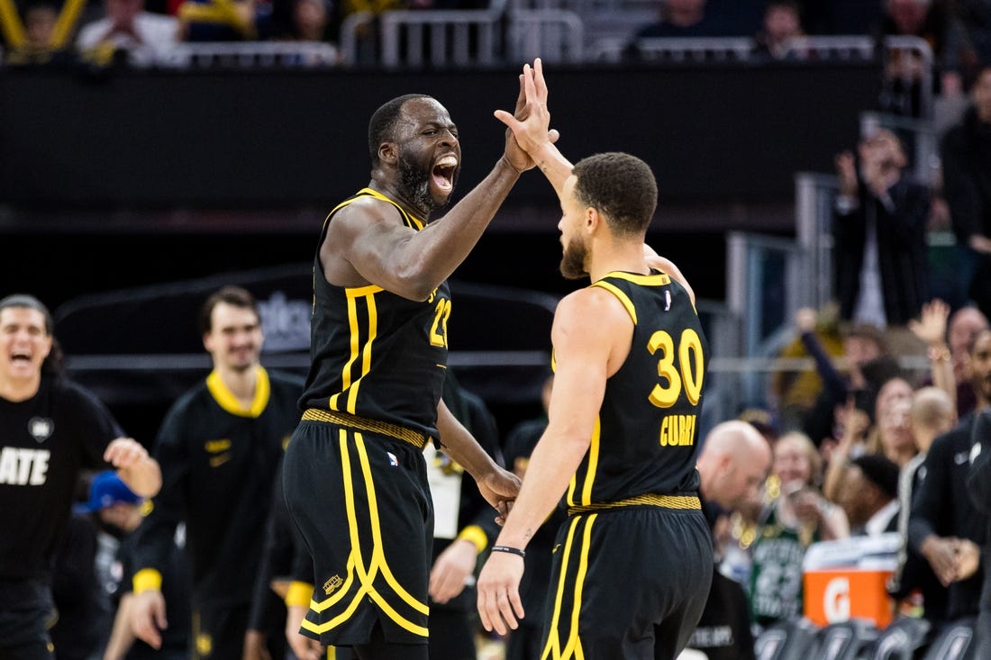 Feb 10, 2024; San Francisco, California, USA; Golden State Warriors center Draymond Green (23) and guard Stephen Curry (30) celebrate after scoring against the Phoenix Suns during the second half at Chase Center. Mandatory Credit: John Hefti-USA TODAY Sports