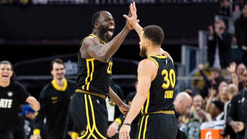 Feb 10, 2024; San Francisco, California, USA; Golden State Warriors center Draymond Green (23) and guard Stephen Curry (30) celebrate after scoring against the Phoenix Suns during the second half at Chase Center. Mandatory Credit: John Hefti-USA TODAY Sports