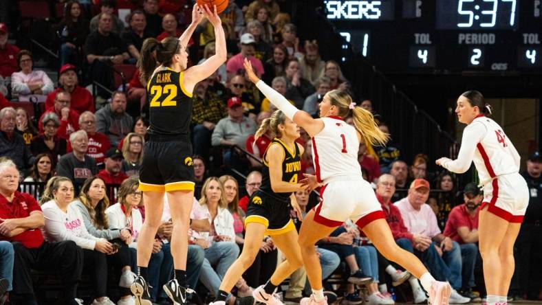 Feb 11, 2024; Lincoln, Nebraska, USA; Iowa Hawkeyes guard Caitlin Clark (22) shoots a three point shot against Nebraska Cornhuskers guard Jaz Shelley (1) during the second quarter at Pinnacle Bank Arena. Mandatory Credit: Dylan Widger-USA TODAY Sports