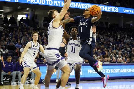 Feb 11, 2024; Evanston, Illinois, USA; Northwestern Wildcats forward Luke Hunger (33) defends Penn State Nittany Lions guard Ace Baldwin Jr. (1) during the first half at Welsh-Ryan Arena. Mandatory Credit: David Banks-USA TODAY Sports