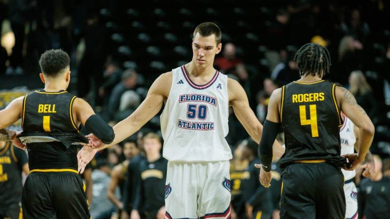 Feb 11, 2024; Wichita, Kansas, USA; Florida Atlantic Owls center Vladislav Goldin (50) slaps hands with Wichita State Shockers guard Xavier Bell (1) and Wichita State Shockers guard Colby Rogers (4) after the game at Charles Koch Arena. Mandatory Credit: William Purnell-USA TODAY Sports