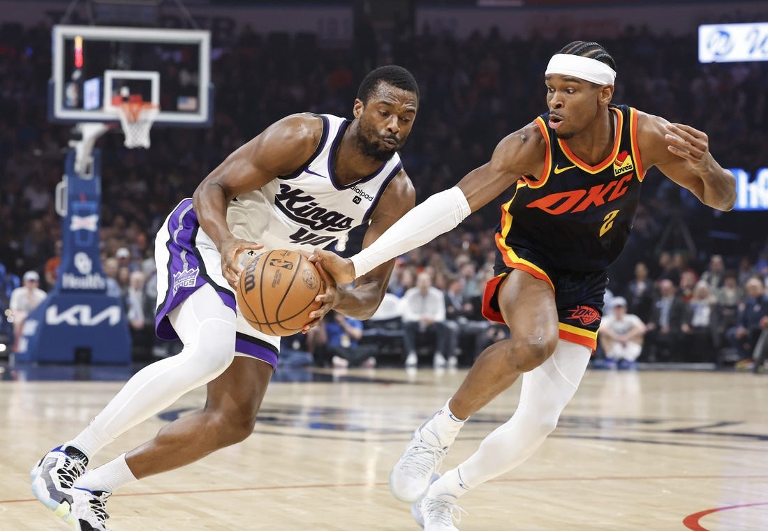 Feb 11, 2024; Oklahoma City, Oklahoma, USA; Oklahoma City Thunder guard Shai Gilgeous-Alexander (2) reaches to steal the ball from Sacramento Kings forward Harrison Barnes (40) during the first quarter at Paycom Center. Mandatory Credit: Alonzo Adams-USA TODAY Sports