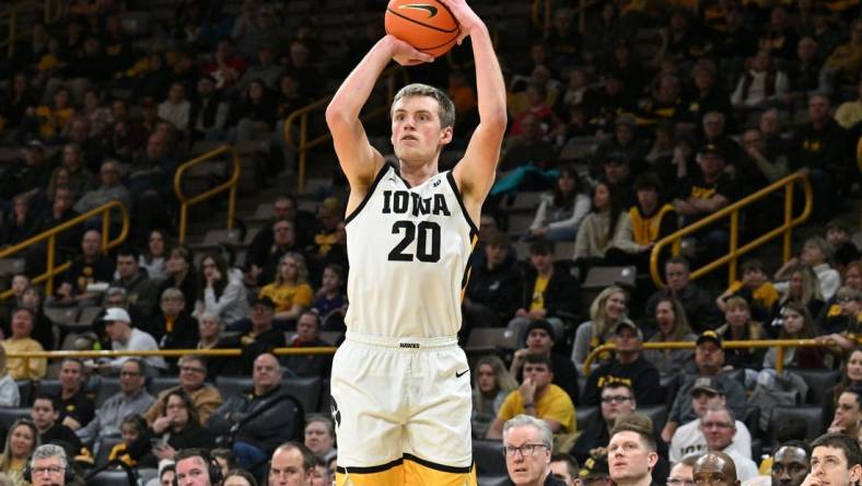 Feb 11, 2024; Iowa City, Iowa, USA; Iowa Hawkeyes forward Payton Sandfort (20) attempts a three point basket against the Minnesota Golden Gophers during the second half at Carver-Hawkeye Arena. Mandatory Credit: Jeffrey Becker-USA TODAY Sports