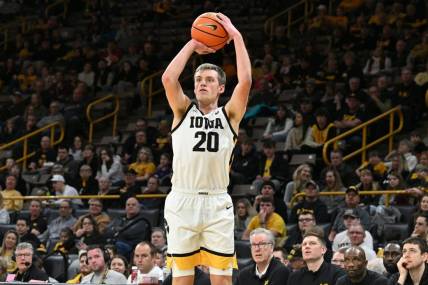 Feb 11, 2024; Iowa City, Iowa, USA; Iowa Hawkeyes forward Payton Sandfort (20) attempts a three point basket against the Minnesota Golden Gophers during the second half at Carver-Hawkeye Arena. Mandatory Credit: Jeffrey Becker-USA TODAY Sports