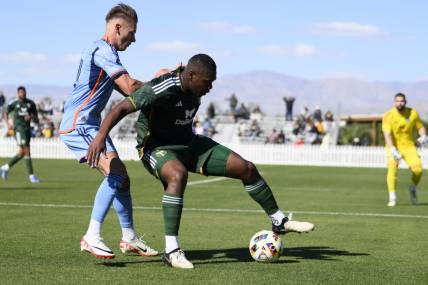 Feb 10, 2024; Indio, CA, USA; Portland Timbers defender Kamal Miller (4) moves the ball while New York City FC forward Hannes Wolf (17) defends at Empire Polo Club. Mandatory Credit: Kelvin Kuo-USA TODAY Sports