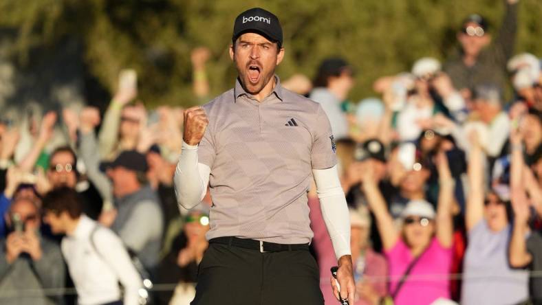 Feb 11, 2024; Scottsdale, AZ, USA; Nick Taylor reacts after making his birdie putt to force a playoff with Charley Hoffman
on the 18th hole during the final round of the WM Phoenix Open at TPC Scottsdale. Mandatory Credit: Rob Schumacher-Arizona Republic