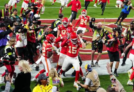 Feb 11, 2024; Paradise, Nevada, USA; Kansas City Chiefs quarterback Patrick Mahomes (15) celebrates after throwing the winning touchdown to wide receiver Mecole Hardman Jr. (12) during overtime against the San Francisco 49ers in Super Bowl LVIII at Allegiant Stadium. Mandatory Credit: Stephen R. Sylvanie-USA TODAY Sports