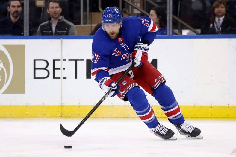 Feb 12, 2024; New York, New York, USA; New York Rangers right wing Blake Wheeler (17) skates with the puck against the Calgary Flames during the first period at Madison Square Garden. Mandatory Credit: Brad Penner-USA TODAY Sports