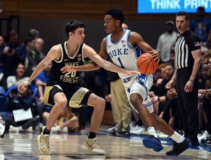 Feb 12, 2024; Durham, North Carolina, USA;  Duke Blue Devils guard Caleb Foster (1) controls the ball in front of Wake Forest Deamon Deacons guard Parker Friedrichsen (20) during the first half at Cameron Indoor Stadium. Mandatory Credit: Rob Kinnan-USA TODAY Sports
