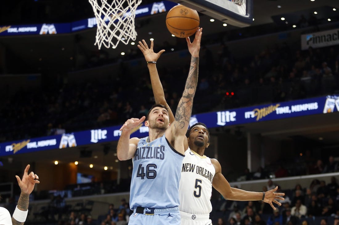 Feb 12, 2024; Memphis, Tennessee, USA; Memphis Grizzlies guard John Konchar (46) shoots as New Orleans Pelicans forward Herbert Jones (5) defends during the first half at FedExForum. Mandatory Credit: Petre Thomas-USA TODAY Sports