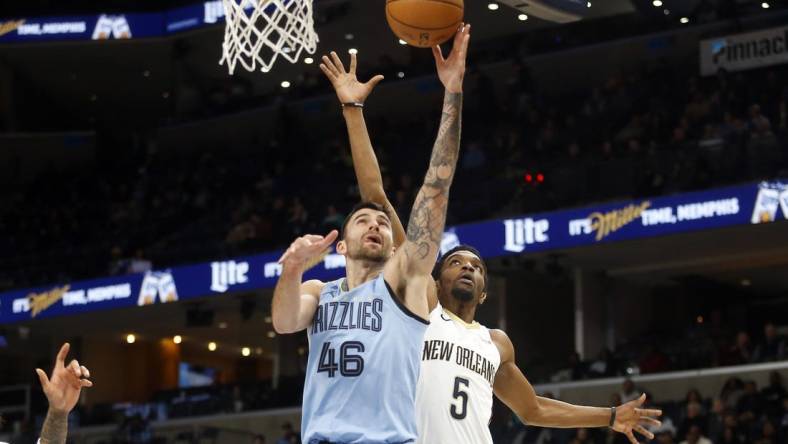 Feb 12, 2024; Memphis, Tennessee, USA; Memphis Grizzlies guard John Konchar (46) shoots as New Orleans Pelicans forward Herbert Jones (5) defends during the first half at FedExForum. Mandatory Credit: Petre Thomas-USA TODAY Sports