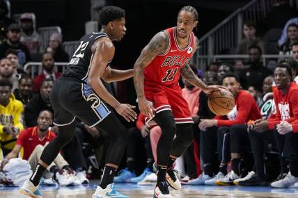 Feb 12, 2024; Atlanta, Georgia, USA; Chicago Bulls forward DeMar DeRozan (11) dribbles against Atlanta Hawks forward De'Andre Hunter (12) during the first half at State Farm Arena. Mandatory Credit: Dale Zanine-USA TODAY Sports