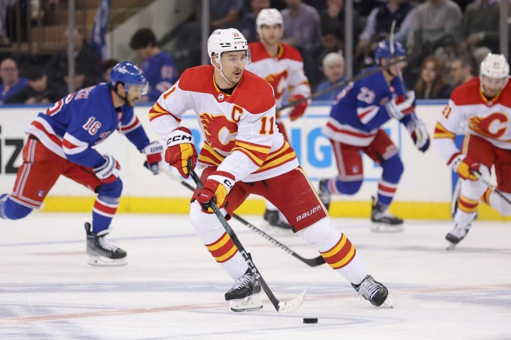 Feb 12, 2024; New York, New York, USA; Calgary Flames center Mikael Backlund (11) skates with the puck against the New York Rangers during the second period at Madison Square Garden. Mandatory Credit: Brad Penner-USA TODAY Sports