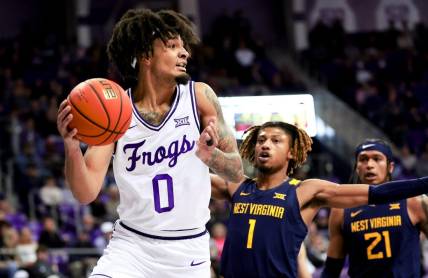 Feb 12, 2024; Fort Worth, Texas, USA;  TCU Horned Frogs guard Micah Peavy (0) looks to pass as West Virginia Mountaineers guard Noah Farrakhan (1) defends during the first half at Ed and Rae Schollmaier Arena. Mandatory Credit: Kevin Jairaj-USA TODAY Sports