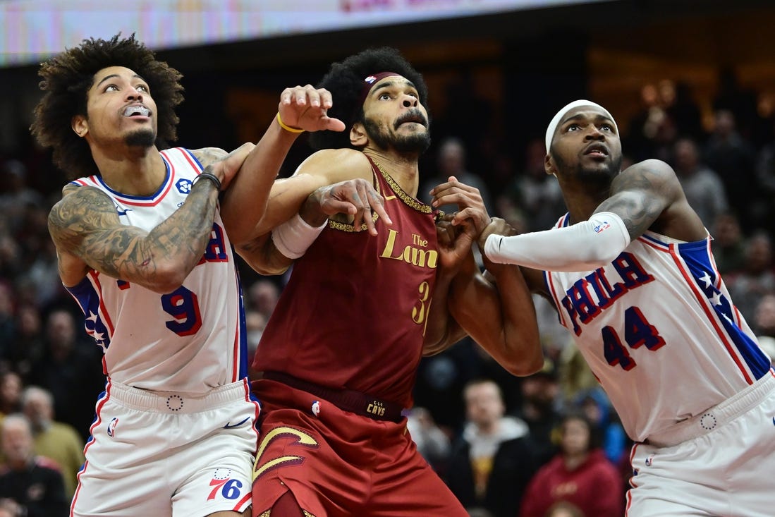 Feb 12, 2024; Cleveland, Ohio, USA; Cleveland Cavaliers center Jarrett Allen (31) fights for position against Philadelphia 76ers guard Kelly Oubre Jr. (9) and forward Paul Reed (44) during the second half at Rocket Mortgage FieldHouse. Mandatory Credit: Ken Blaze-USA TODAY Sports