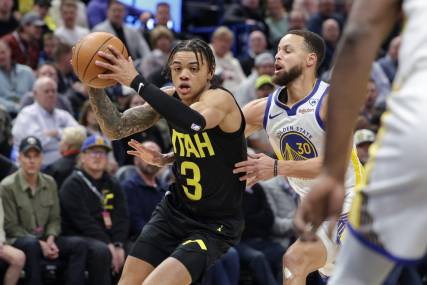 Feb 12, 2024; Salt Lake City, Utah, USA;  Utah Jazz guard Keyonte George (3) tries to get away from Golden State Warriors guard Stephen Curry (30) during the first quarter at Delta Center. Mandatory Credit: Chris Nicoll-USA TODAY Sports