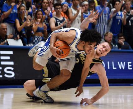 Feb 12, 2024; Durham, North Carolina, USA; Duke Blue Devils guard Jared McCain (0) is fouled as he drives against Wake Forest Deamon Deacons guard Cameron Hildreth (2) during the second half at Cameron Indoor Stadium. The Blue Devils won 77-69. Mandatory Credit: Rob Kinnan-USA TODAY Sports