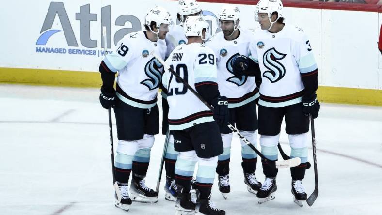 Feb 12, 2024; Newark, New Jersey, USA; Seattle Kraken defenseman Will Borgen (3) celebrates with teammates after scoring a goal against the New Jersey Devils during the third period at Prudential Center. Mandatory Credit: John Jones-USA TODAY Sports
