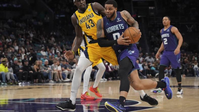 Feb 12, 2024; Charlotte, North Carolina, USA; Charlotte Hornets forward Miles Bridges (0) drives to the basket guarded by Indiana Pacers forward Pascal Siakam (43) during the second half at Spectrum Center. Mandatory Credit: Jim Dedmon-USA TODAY Sports